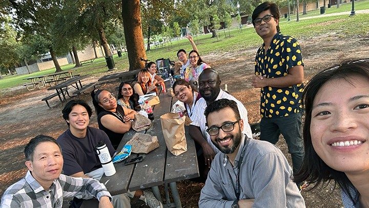Photo of Pan Lab members enjoying a picnic and game day at Hermann Park in Houston