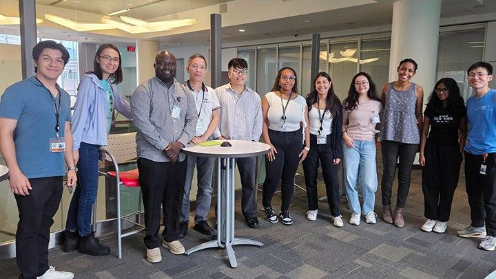 Photo of Pan Lab members wishing farewell to summer interns Alejandra Villanueva and Carlos Cerda