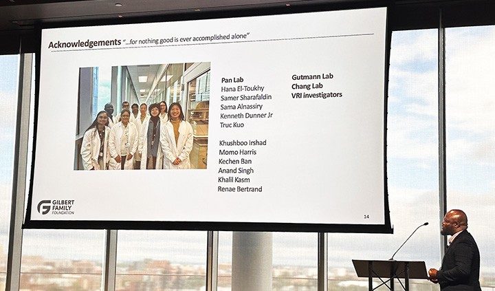 Photo of Pan Lab member Benjamin Aghoghovwia speaking to the Gilbert Family Foundation