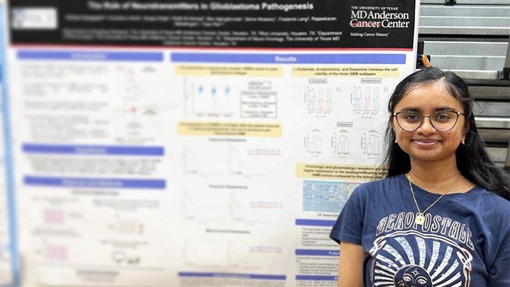 Photo of Pan Lab member Aishani Gargapati beside a research poster