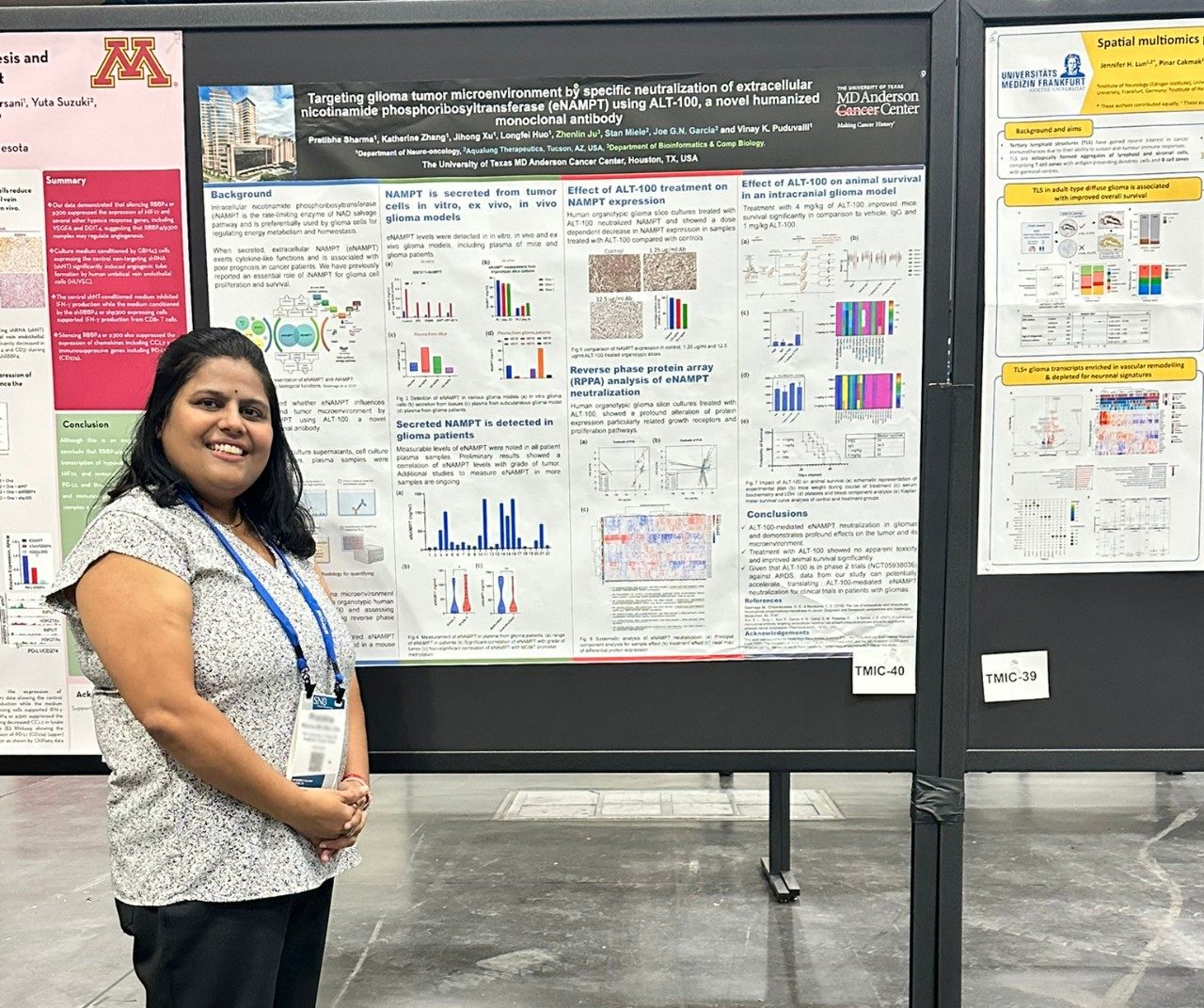 Woman with lanyard around her neck posing next to a poster