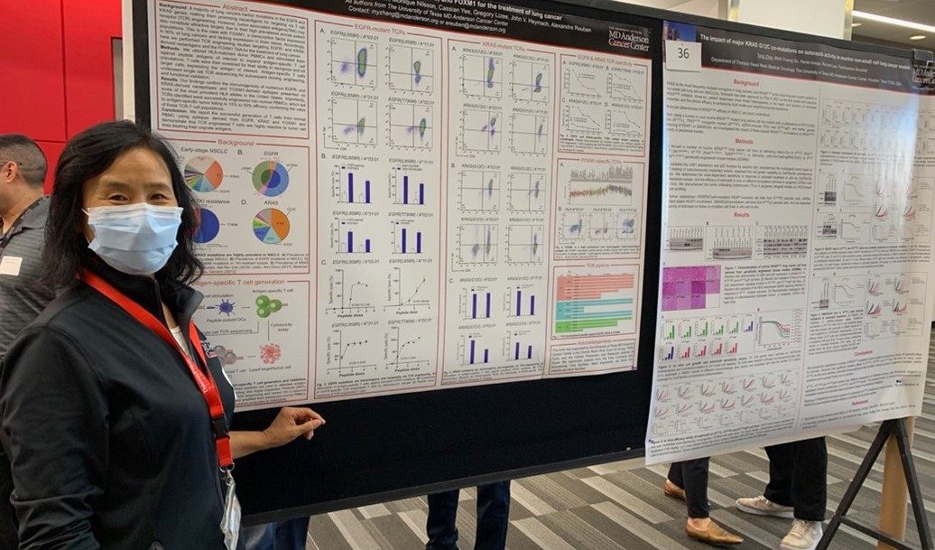 Woman in front of a scientific poster 