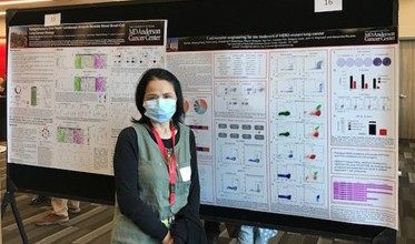 Woman in front of a scientific poster 