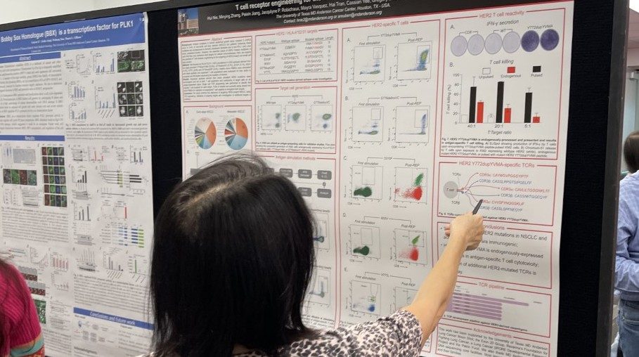 Woman pointing to something on a scientific poster