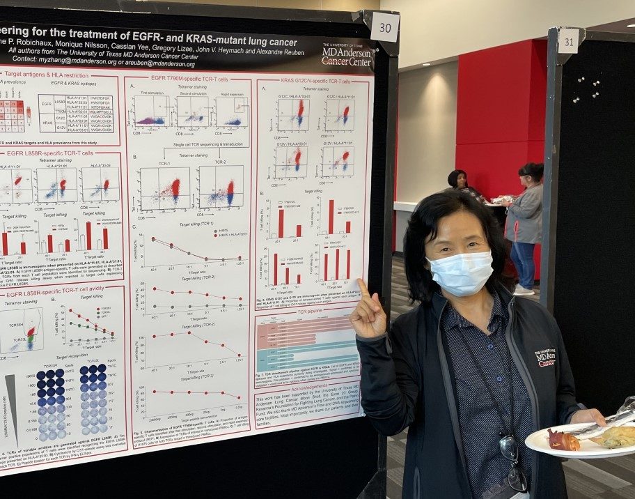 Woman in front of a scientific poster 