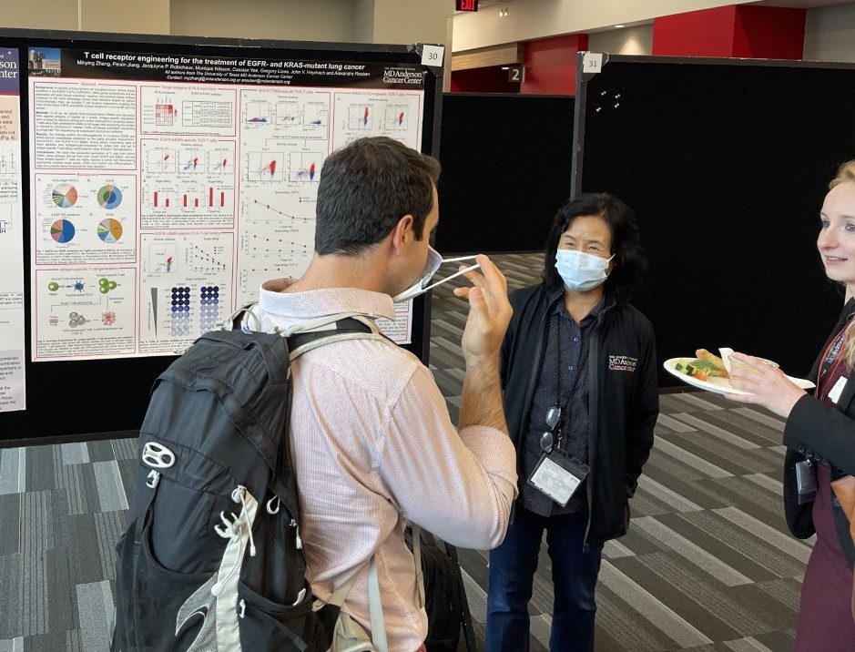 Woman in front of a scientific poster 