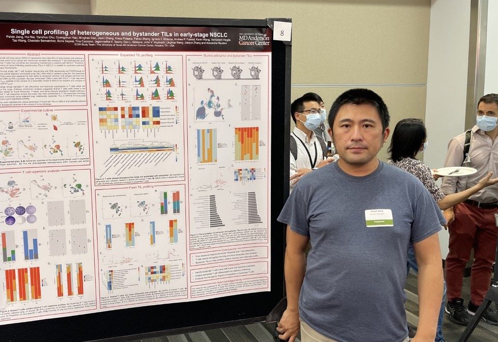 Man in front of a scientific poster