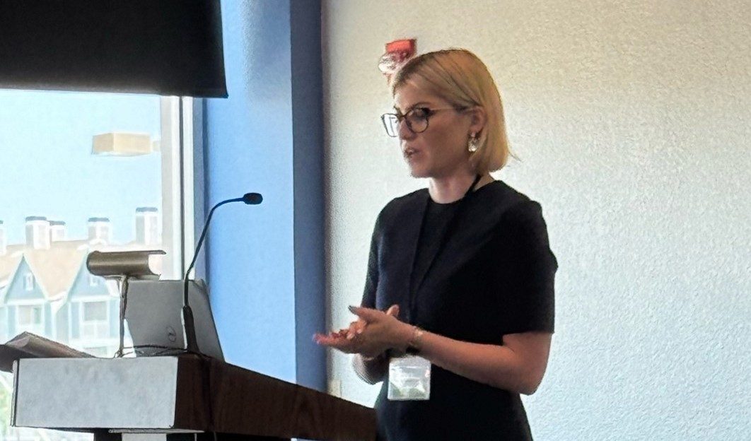 A woman stands behind a podium
