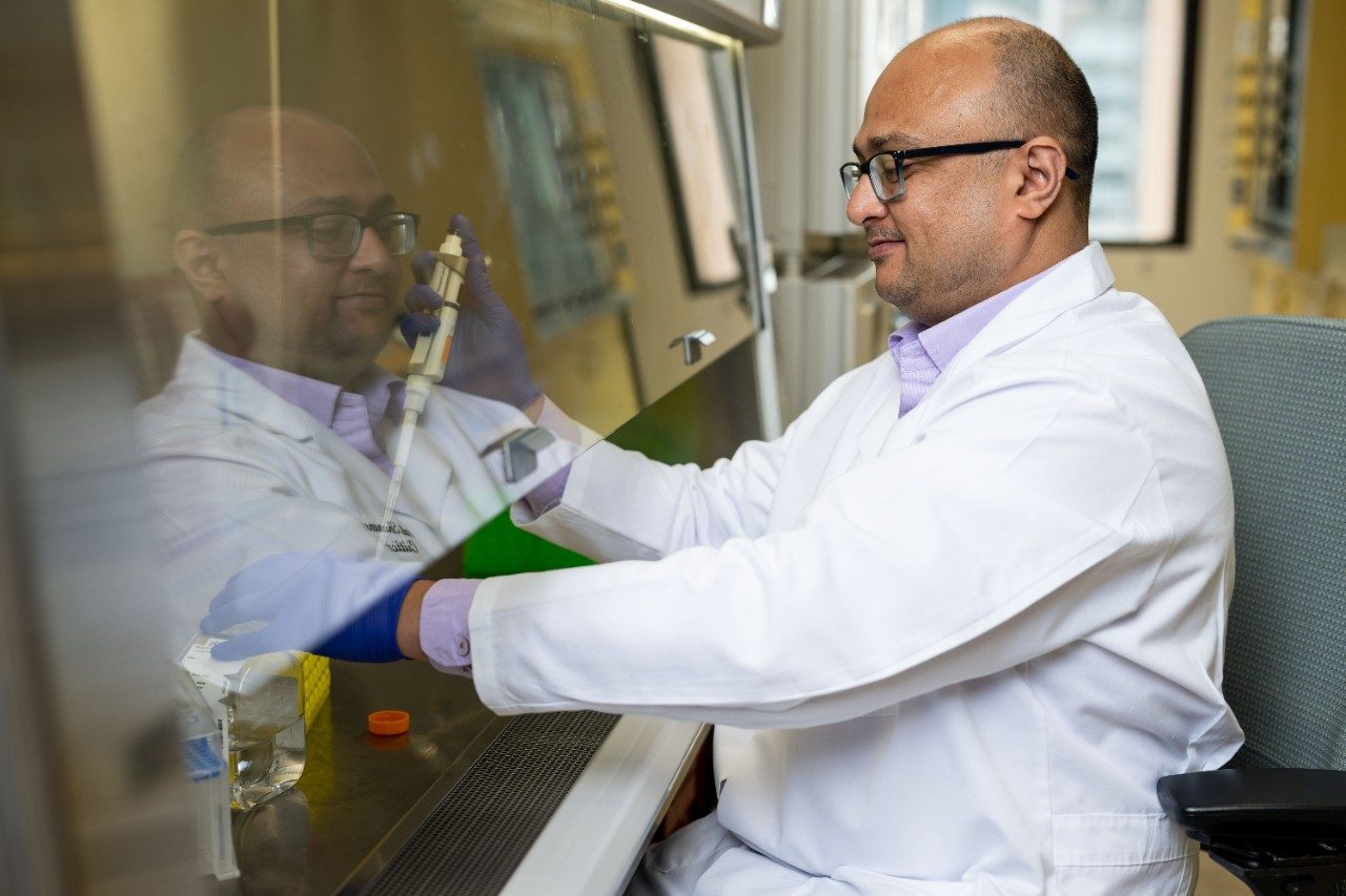 Atul Sharma, Ph.D., works in the lab