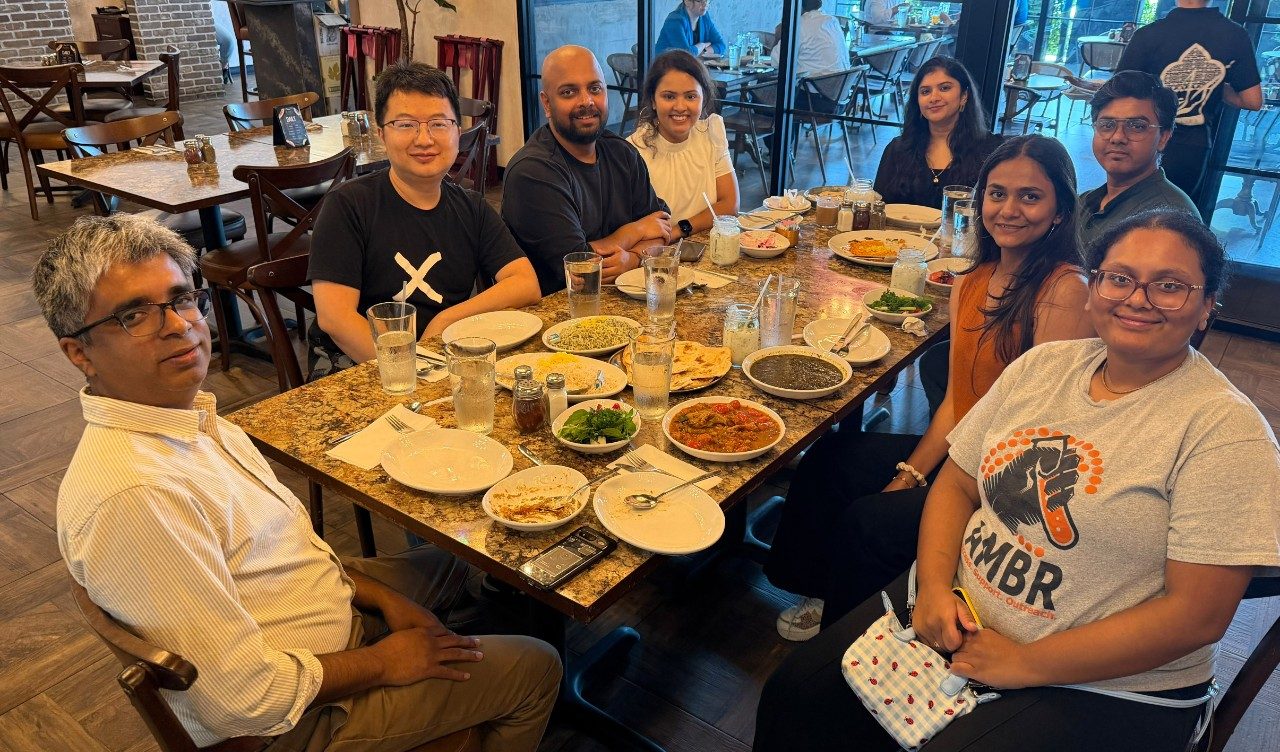 8 people at a table in a restaurant