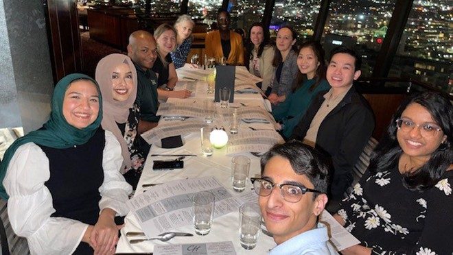 Large group around a table indoors