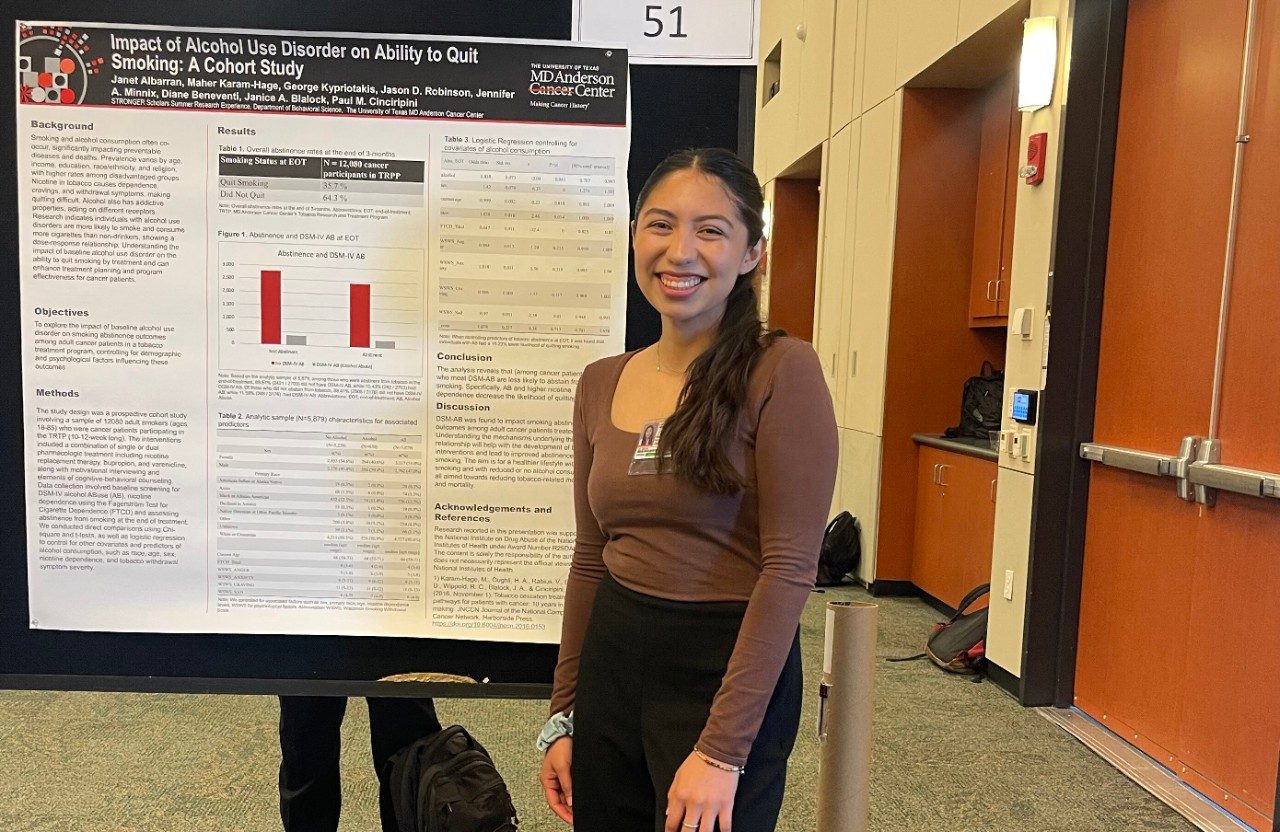 One person posed in front of a scientific poster