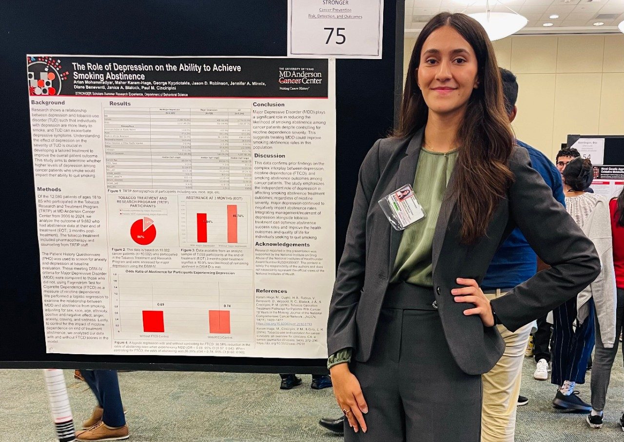 One person posed in front of a scientific poster