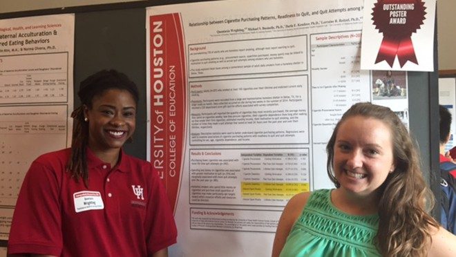 Two women in front of a scientific poster