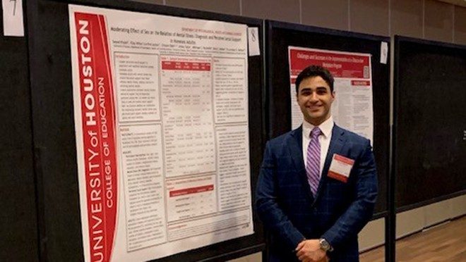 One man in front of a scientific poster