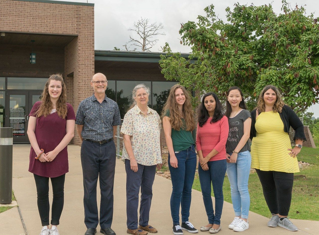 Group photo of the Wood Lab, standing outside of their lab building, Summer 2019