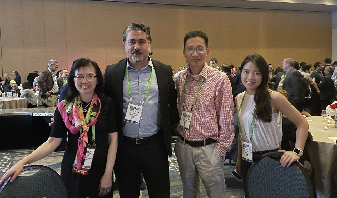 four people pose at a reception