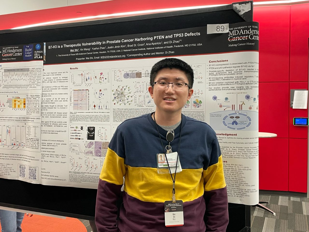 Man standing in front of poster board