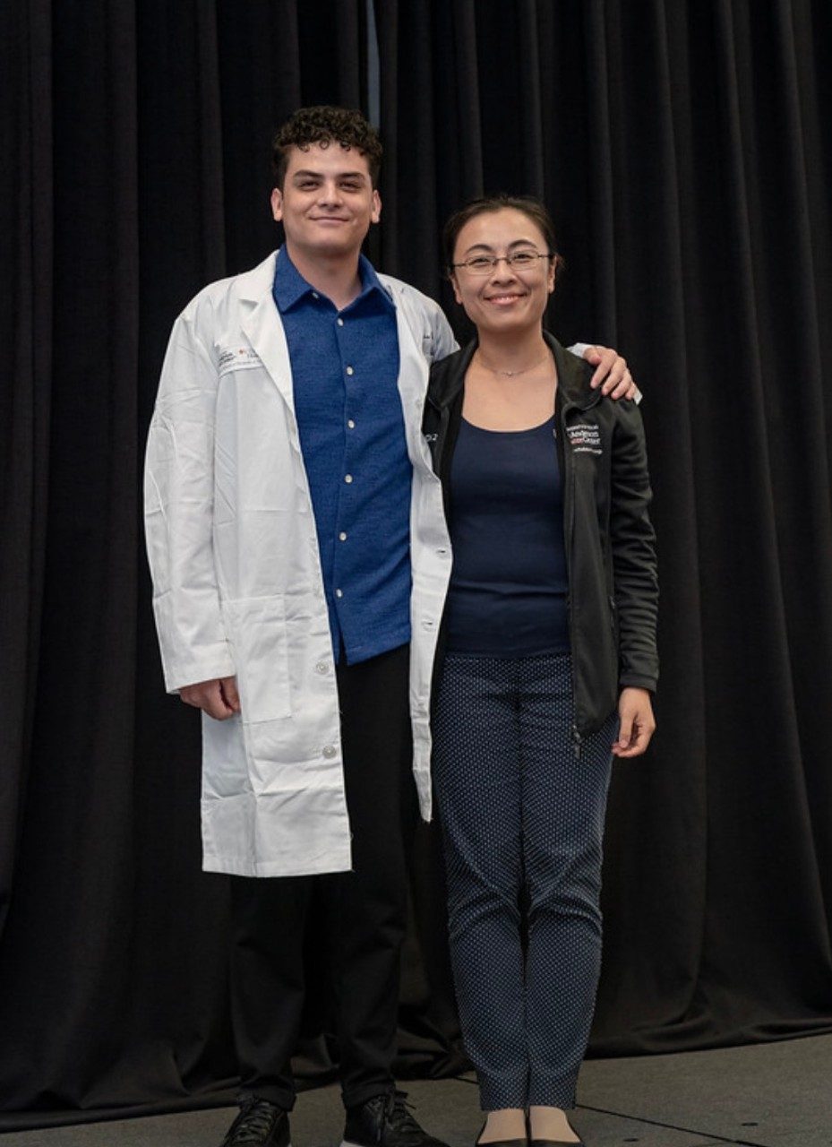Dr. Zhao and a man in a white doctor's coat pose together