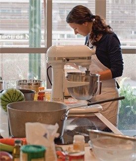 A woman stands in a kitchen