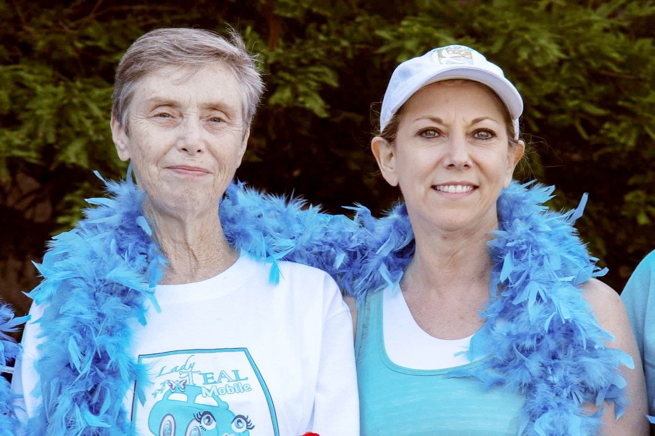 Two people dressed in light blue