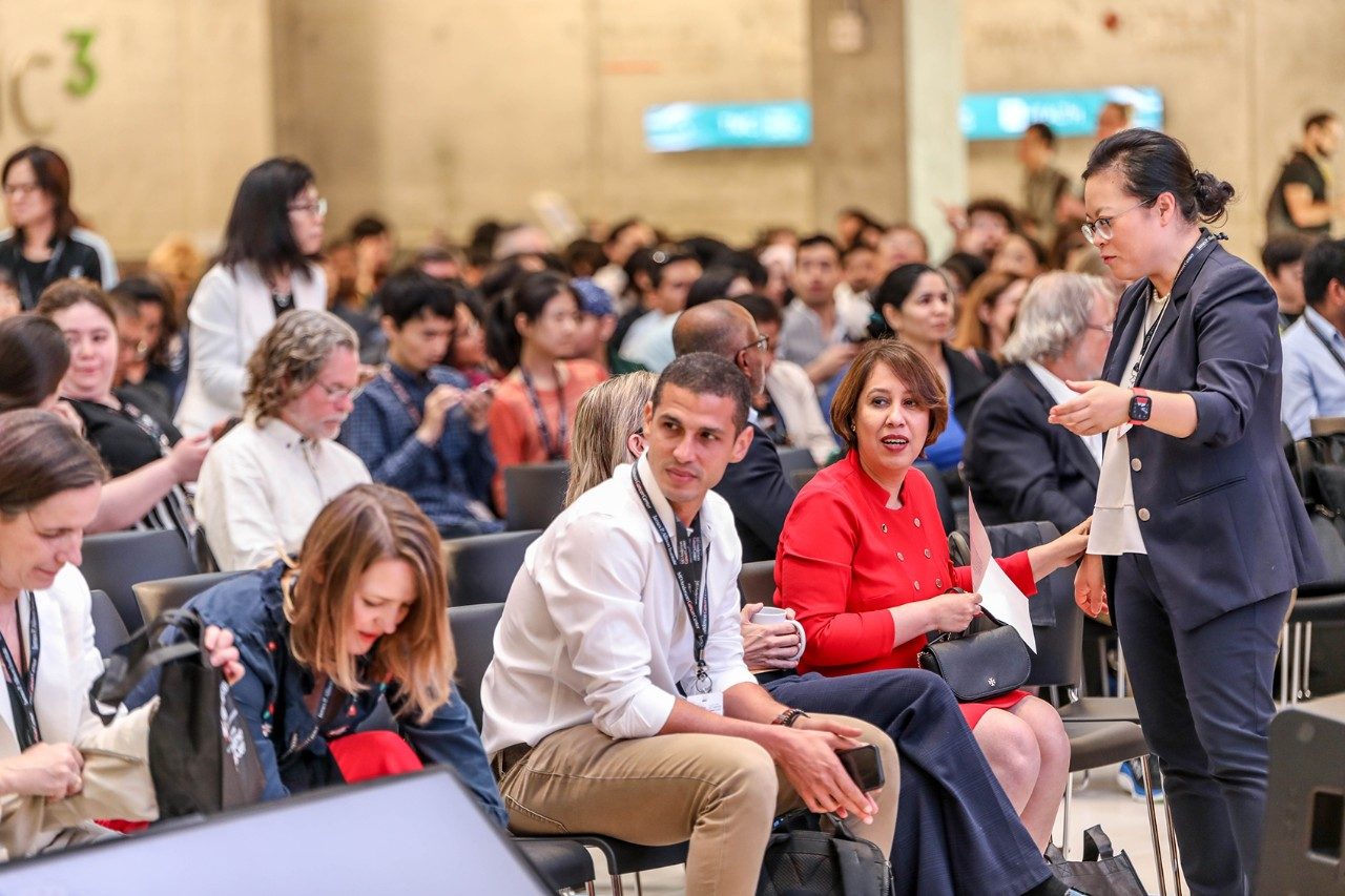 A group of people in business dress, some sitting, some standing