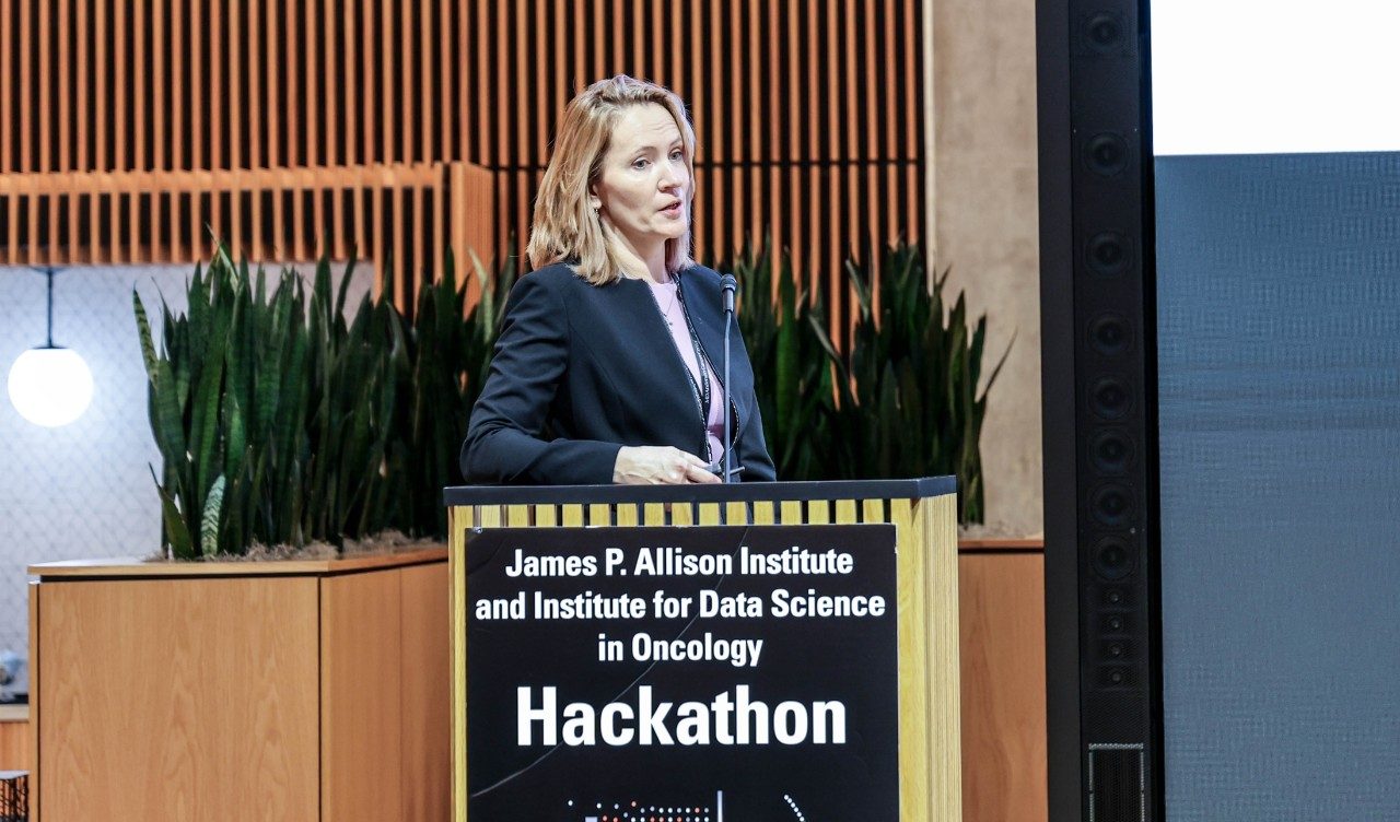 A woman stands at a podium