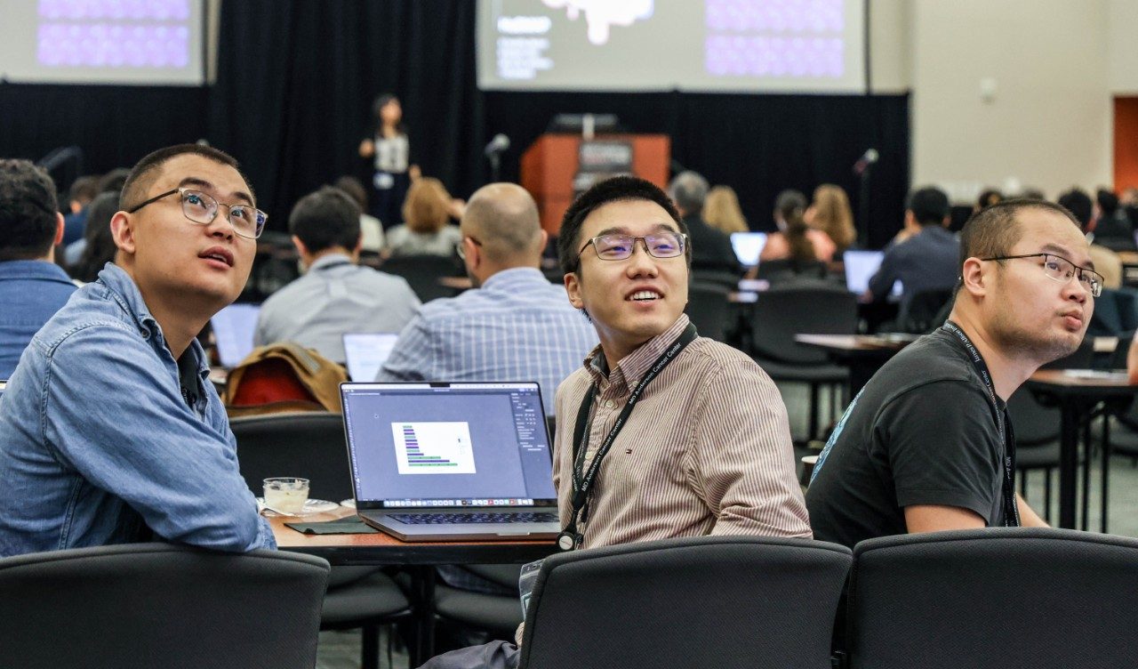 Three men look behind them