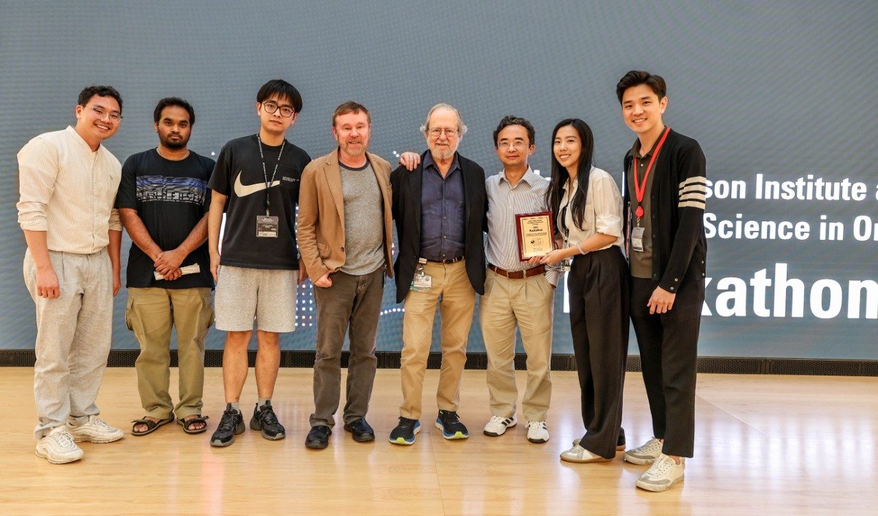 Eight people pose in a line