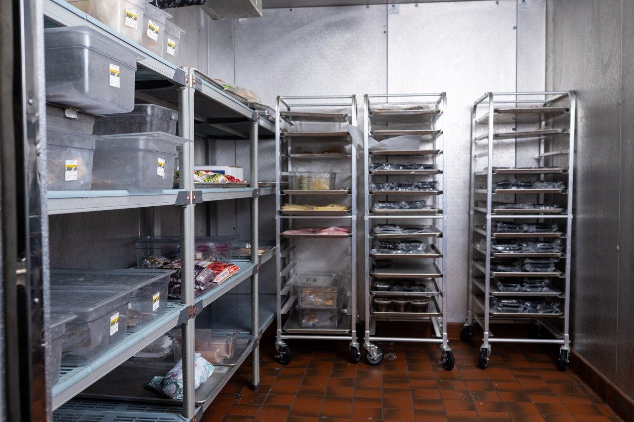 A walk-in freezer with food storage shelves