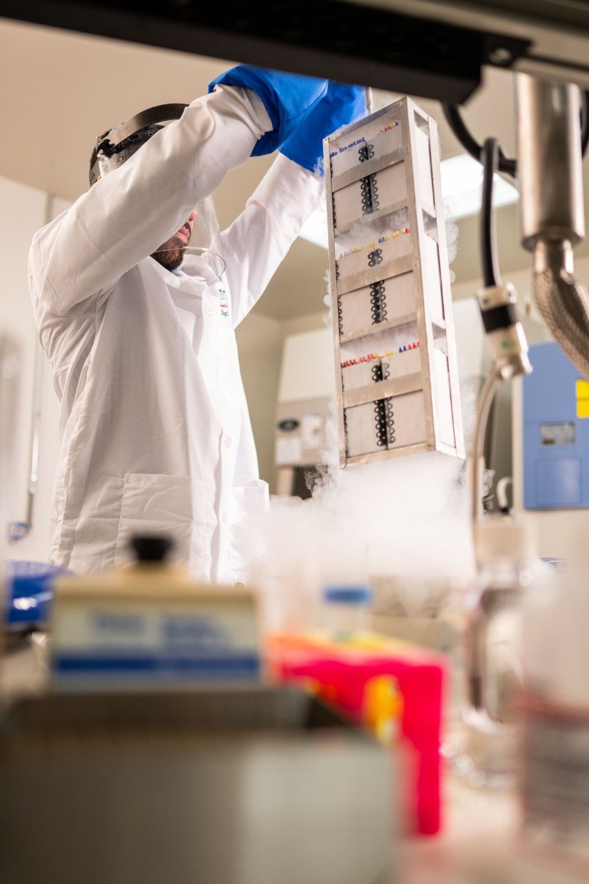 A person in a lab with various supplies 