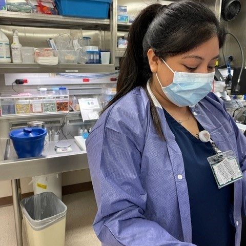 Woman in mask working in a lab