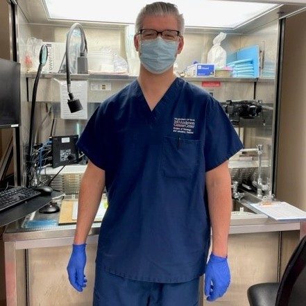 Man in mask and gloves in a lab
